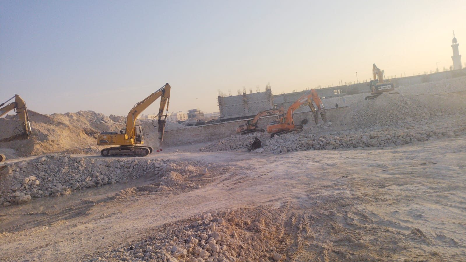Excavators breaking rock during levelling works at Al Wukair, Qatar